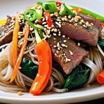 A vibrant and colorful plate of Japchae, featuring glistening glass noodles, julienned vegetables (carrots, onions, spinach, bell peppers), thinly sliced beef, and garnished with sesame seeds and chopped green onions. Focus on the textures and the visual appeal of the dish.