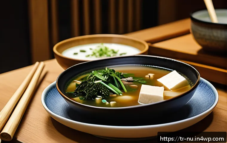 일본식 미소국 기본 레시피 - A cozy, traditional Japanese kitchen scene featuring a steaming bowl of miso soup on a wooden table,...